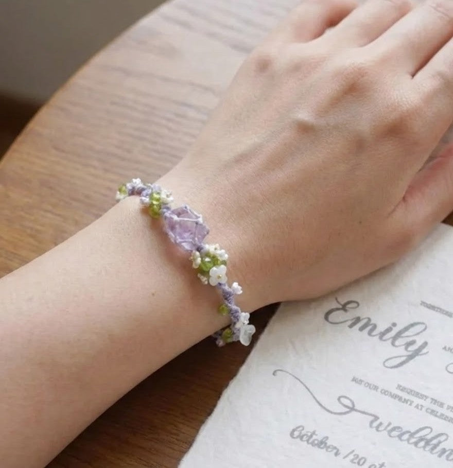 A delicate fusion of art and nature, the Handmade Lavender Iris Bracelet captures the ethereal charm of a Monet-inspired garden. Its intricate Mori-style weaving and vibrant crystal accents offer a healing aesthetic that is both whimsical and serene.