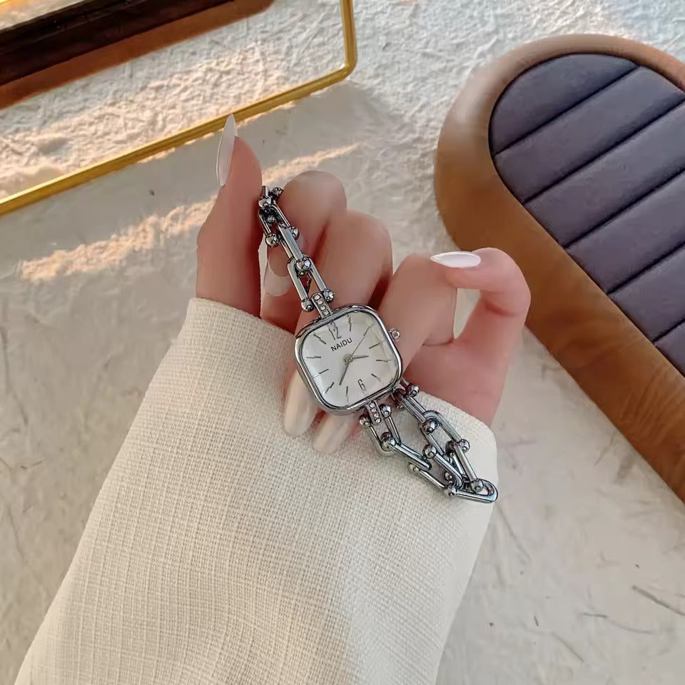 The Elite Eternity Watch redefines elegance with its sophisticated square small dial and a light luxury Cuban-inspired strap. This timepiece seamlessly blends the bold aesthetic of a high-end bracelet with the precision of a modern quartz movement, making it a standout accessory for any trendsetting wardrobe.