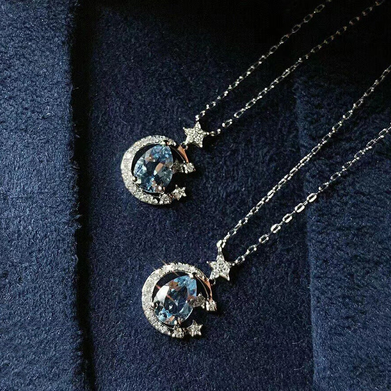 The Moondust Whisper Necklace captures the ethereal beauty of a moonlit sky, featuring a mesmerizing blue water-drop stone nestled within a delicate celestial crescent. It brings a sophisticated sense of wonder to any look.