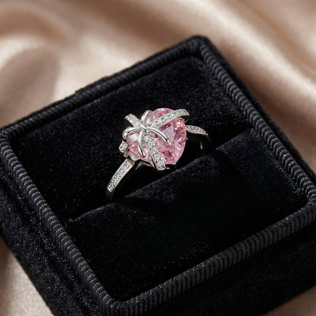 The Tied with Love Ring is a masterpiece of high-design fairy aesthetics, featuring a stunning heart-shaped pink diamond elegantly bound by a shimmering zircon-encrusted knot. 