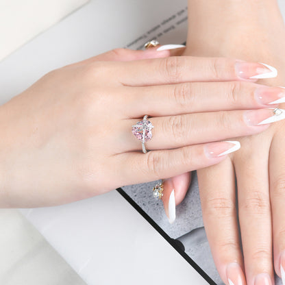 The Tied with Love Ring is a masterpiece of high-design fairy aesthetics, featuring a stunning heart-shaped pink diamond elegantly bound by a shimmering zircon-encrusted knot. 