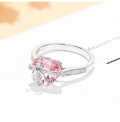 The Tied with Love Ring is a masterpiece of high-design fairy aesthetics, featuring a stunning heart-shaped pink diamond elegantly bound by a shimmering zircon-encrusted knot. 