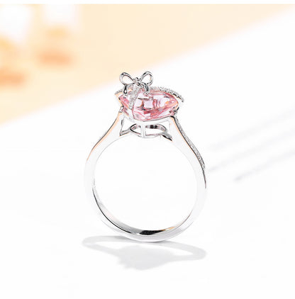 The Tied with Love Ring is a masterpiece of high-design fairy aesthetics, featuring a stunning heart-shaped pink diamond elegantly bound by a shimmering zircon-encrusted knot. 