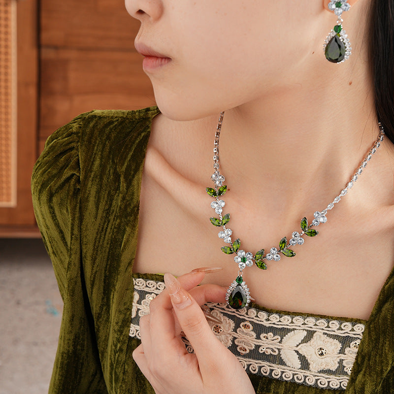 The Verdant Vine Suite offers a high-end necklace and ear rings set, meticulously designed to accentuate the clavicle, bringing a sophisticated sense of design to the modern woman's collection.